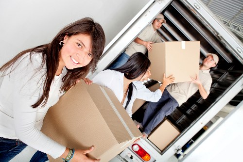 Professional removals team handling furniture in a Streatham apartment building